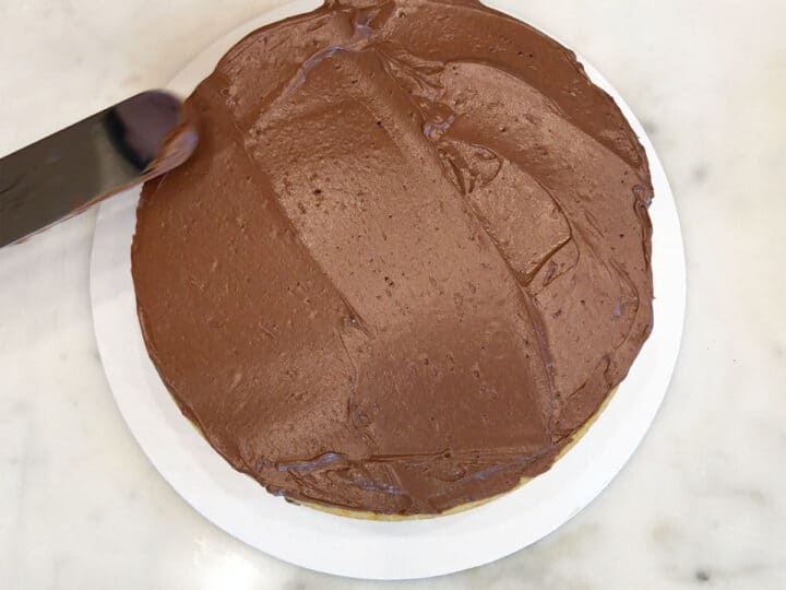 Frosting the second layer of the cake.