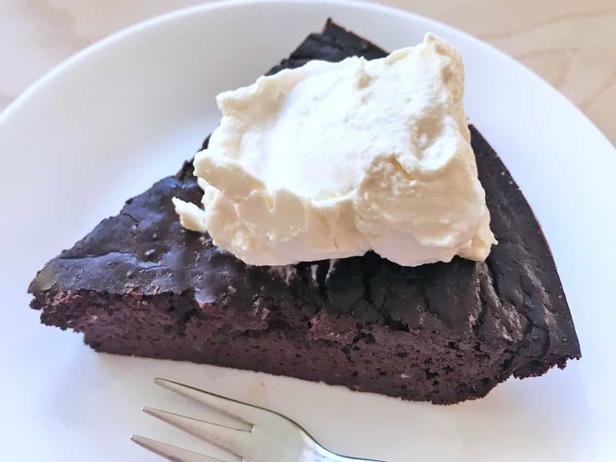 The pie is served with lots of whipped cream.