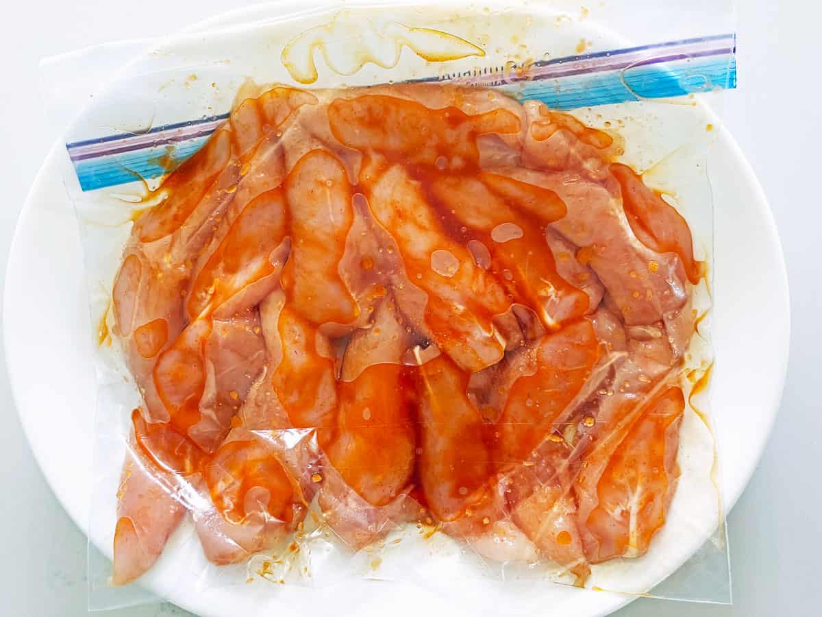 Marinating the chicken tenders in a resealable bag.