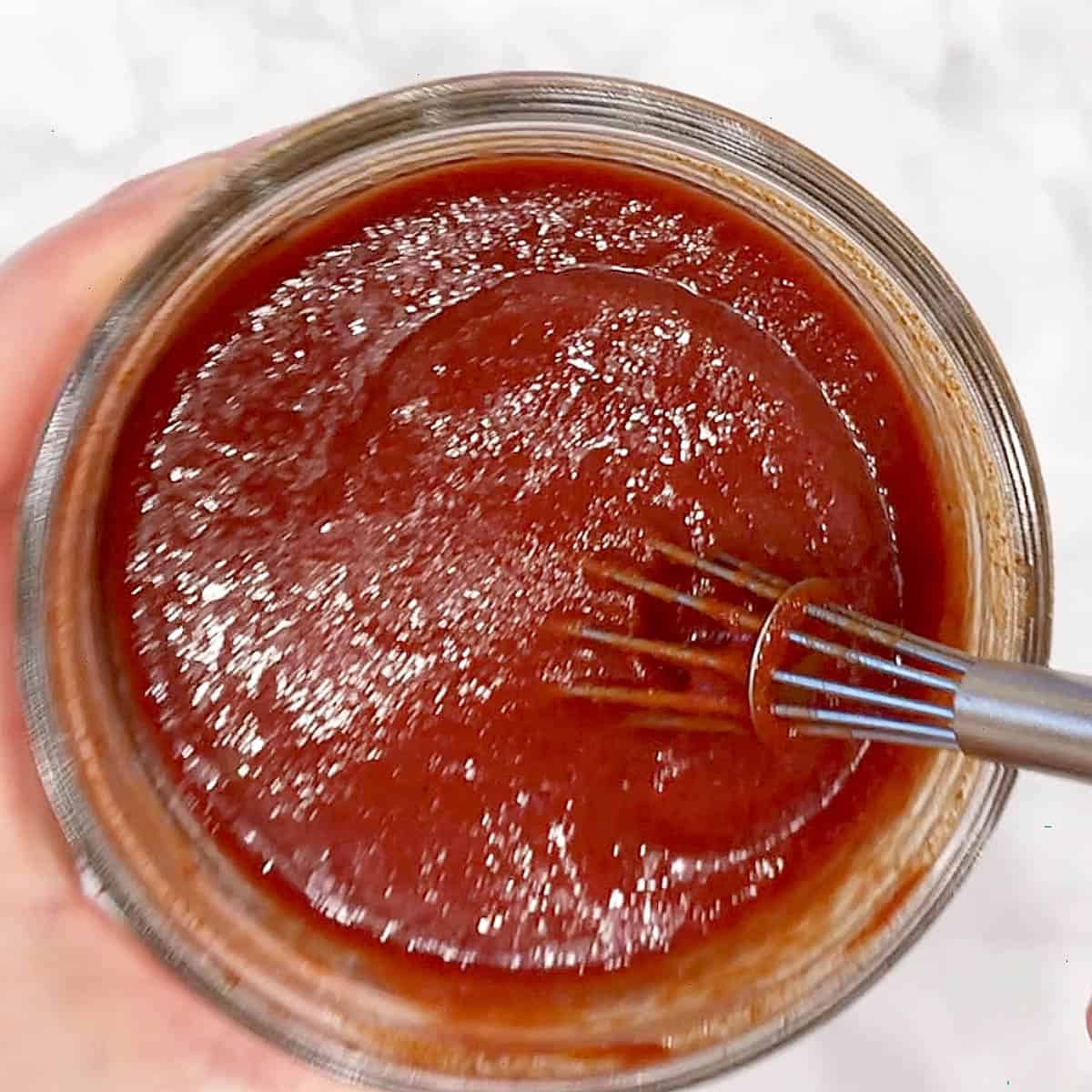 Mixing homemade BBQ sauce.