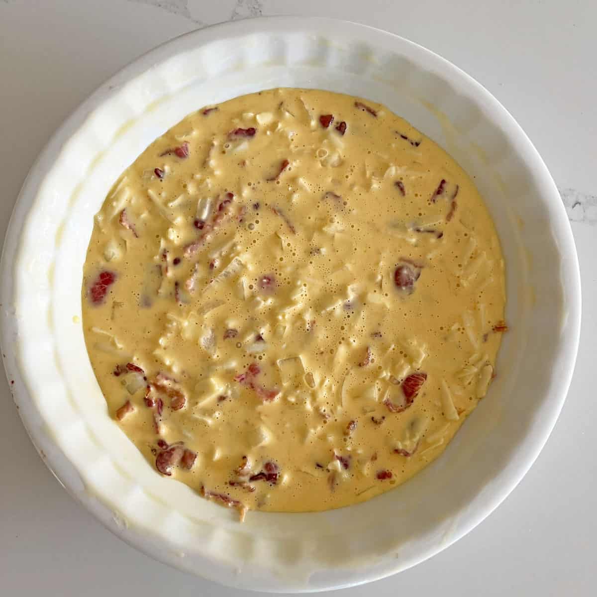 The quiche is ready for the oven.