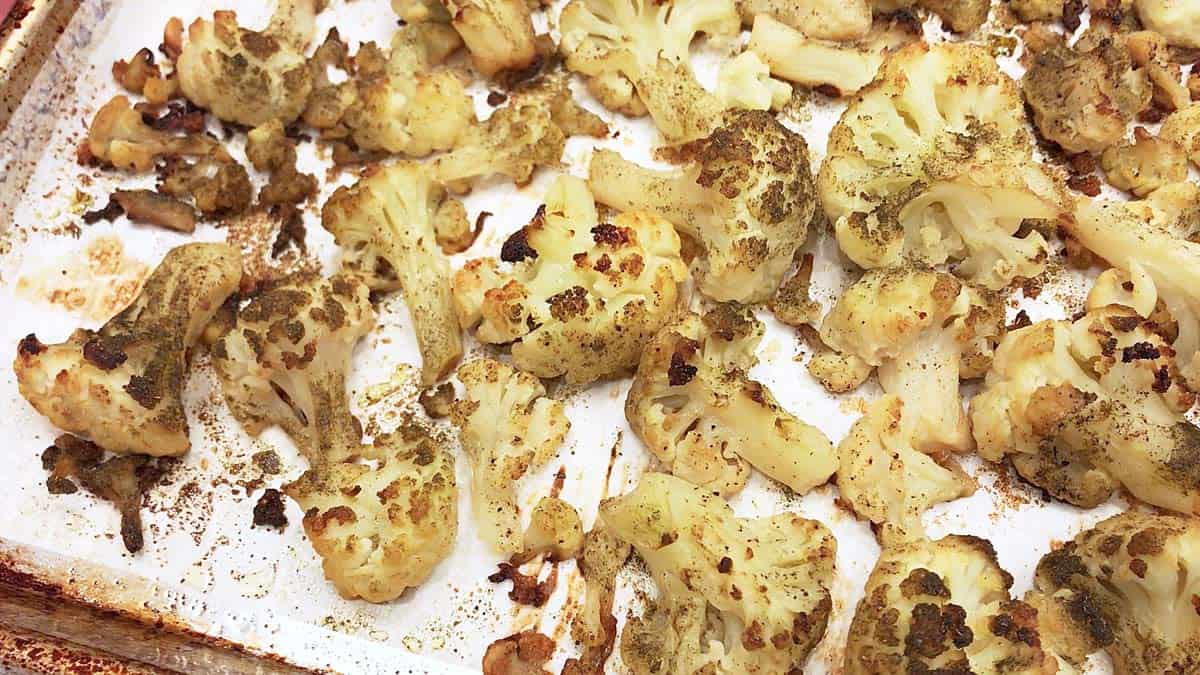 Roasted frozen cauliflower is ready on the baking sheet.