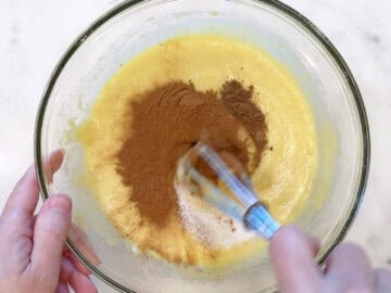 Mixing in cinnamon, allspice, and salt.