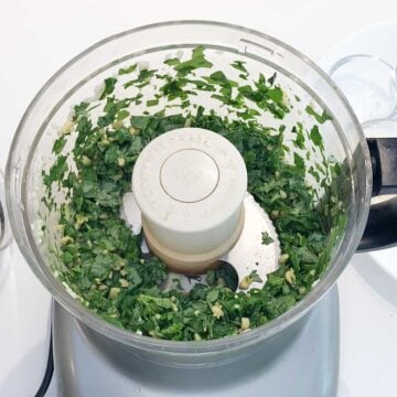 Basil and pine nuts were chopped in the food processor.
