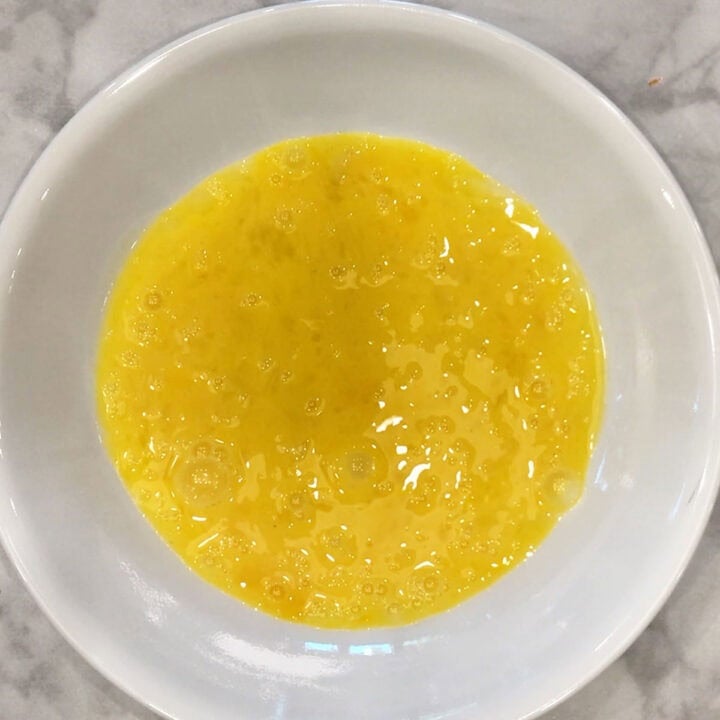 A bowl with whisked eggs.