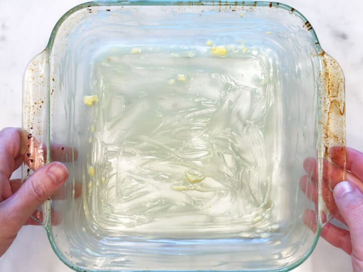 A buttered square baking dish.