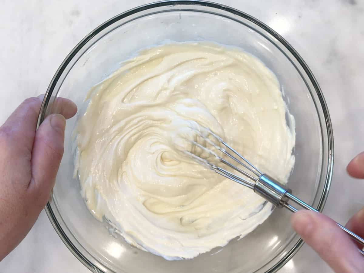 Mixing the frosting in a bowl.