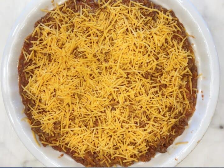 The pie mixture was transferred to the pan and topped with cheese.