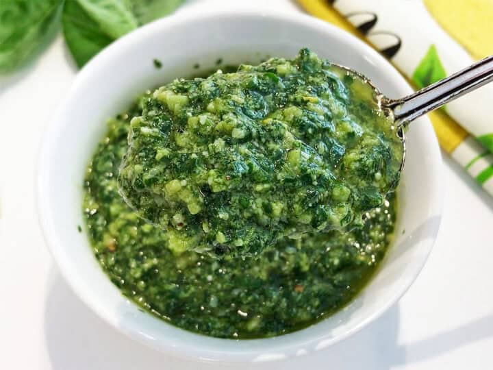 Pesto sauce is served with a spoon.