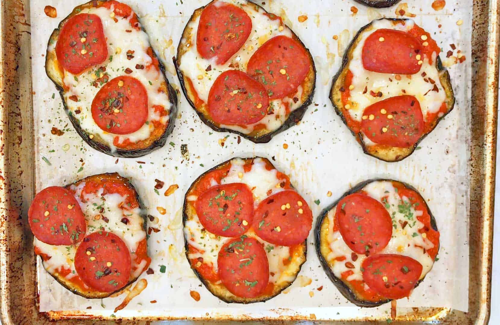 The eggplant pizza bites are ready in the pan.