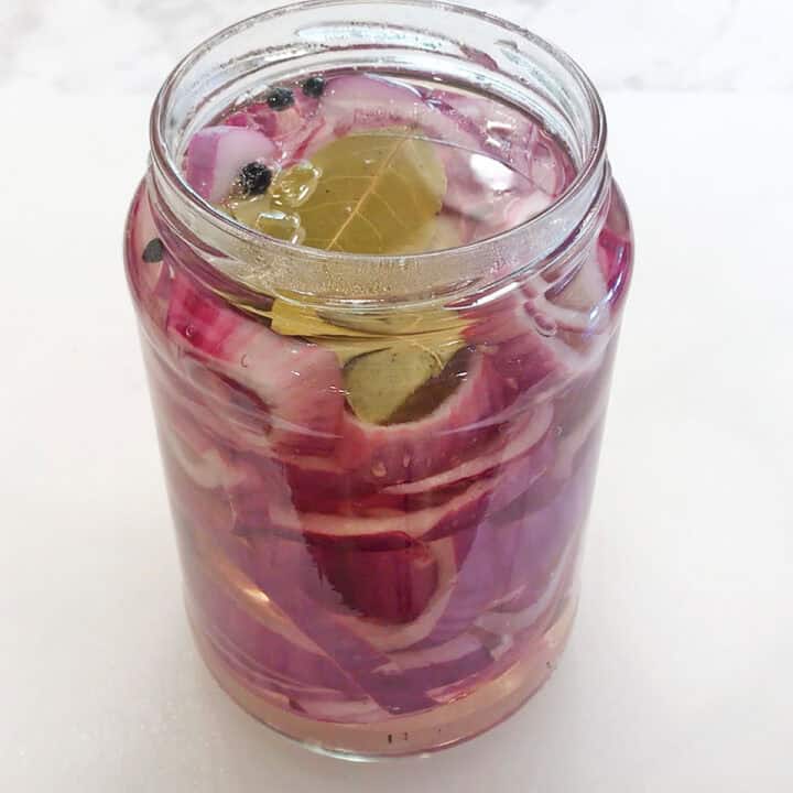 The water-vinegar solution was added to the jar with the red onions.