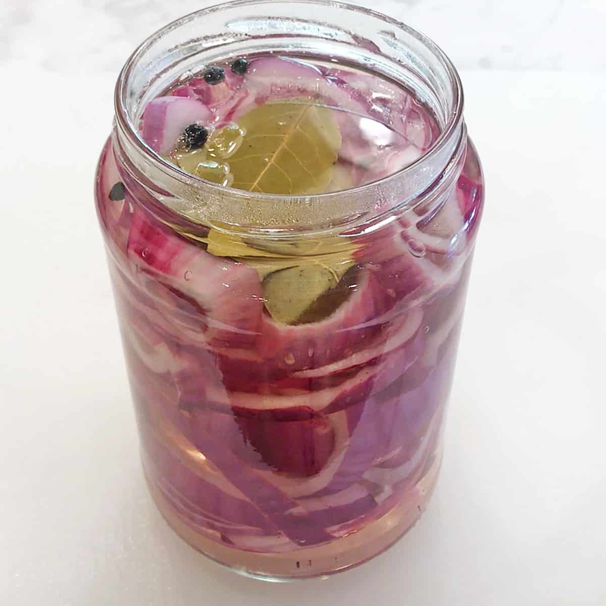 The water-vinegar solution was added to the jar with the red onions.