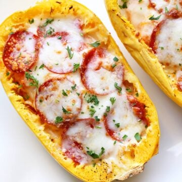Spaghetti squash pizza is served on a white plate.