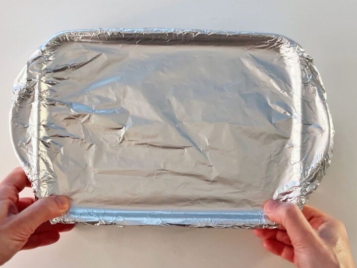 Covering the baking dish in layers of foil.