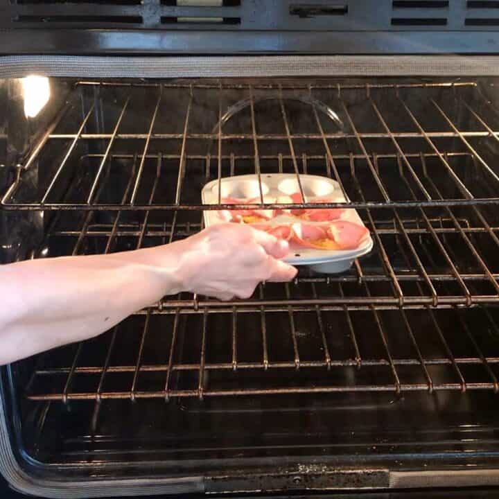 Placing the cups in the oven.
