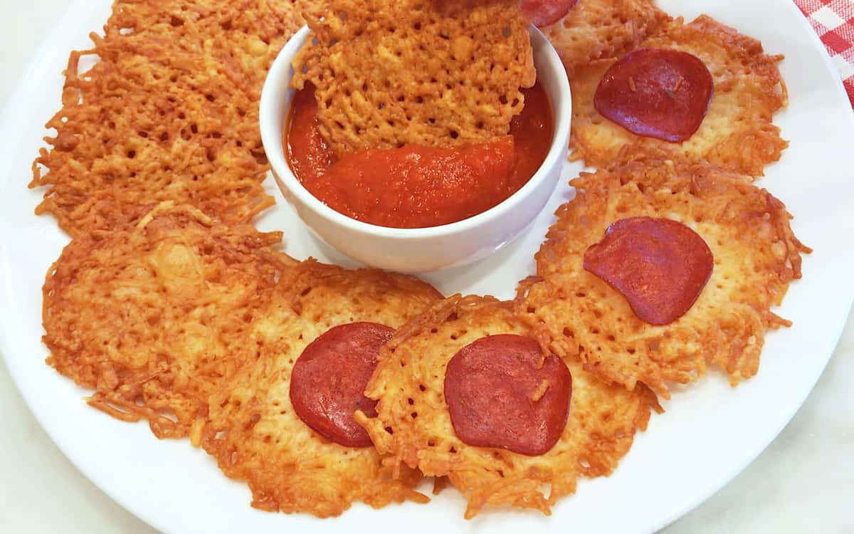 Parmesan crisps are served with a dipping sauce.