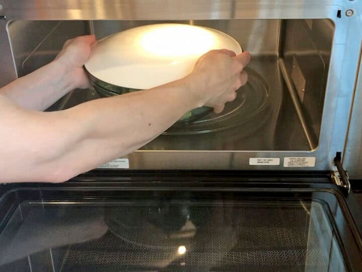 Placing the vegetables in the microwave.