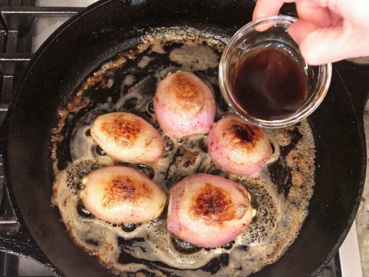 Adding balsamic vinegar to the skillet.