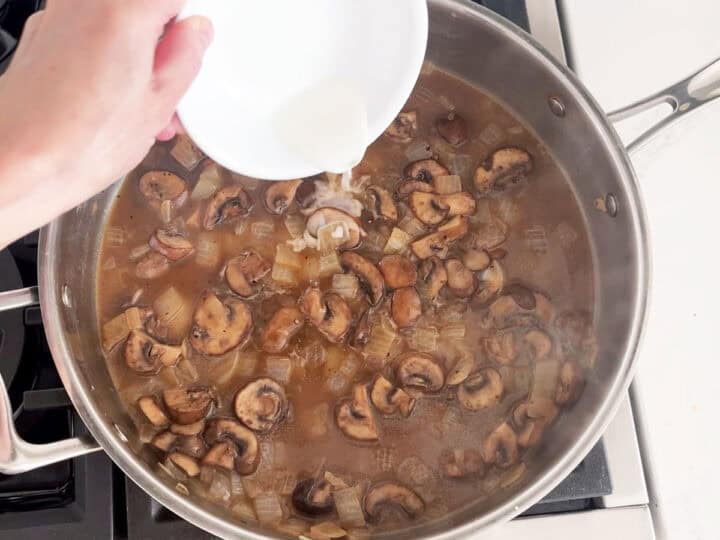 Adding cornstarch to the sauce.