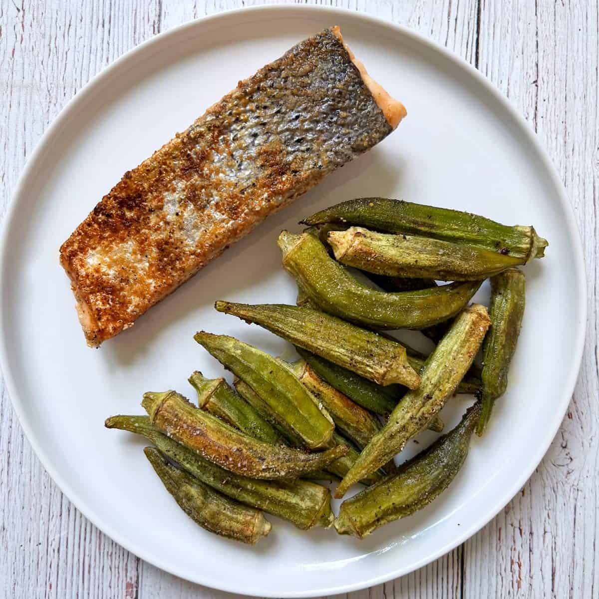 Roasted okra is served with salmon.