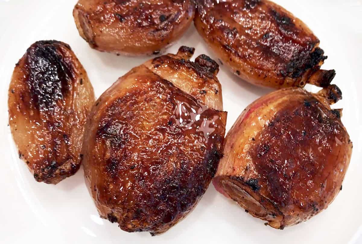 The shallots are served on a white plate.