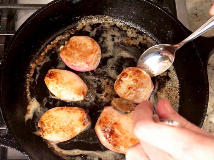 Turning the shallots in the skillet.
