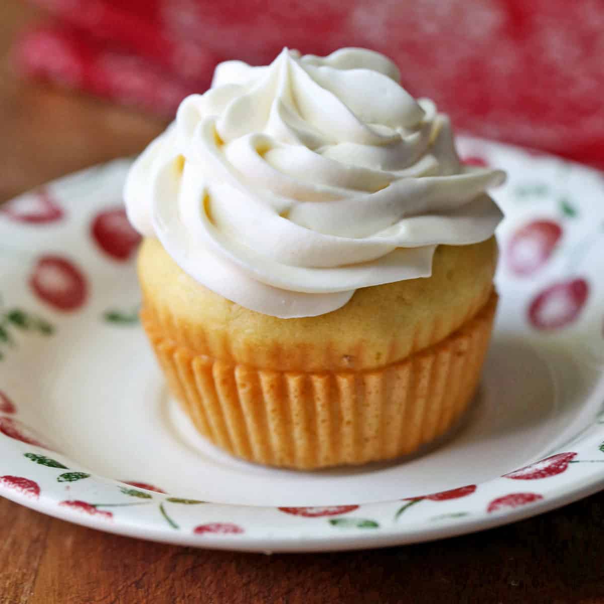A cupcake is topped with keto cream cheese frosting.