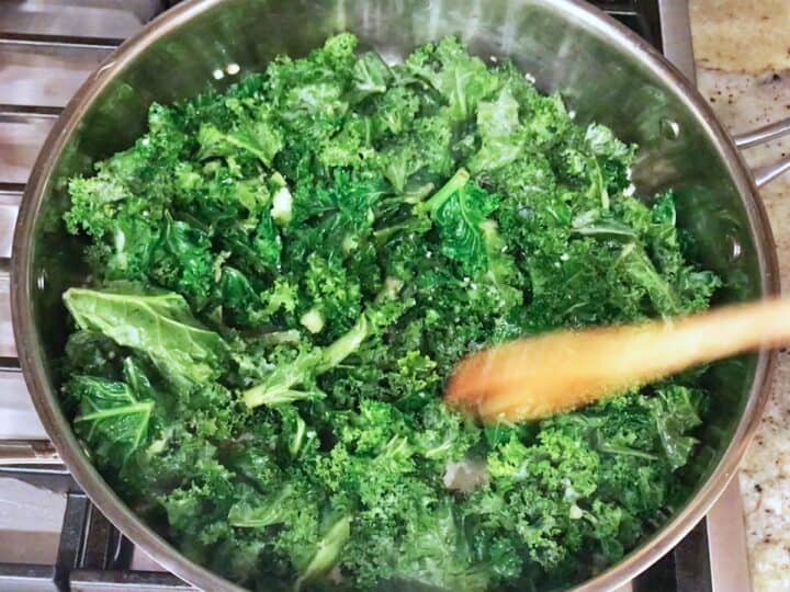 The raw kale was added to the skillet.