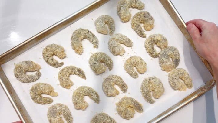The coated shrimp were arranged on the baking sheet.