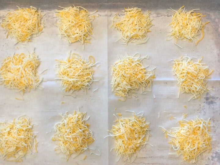 Cheese mounds on a baking sheet.