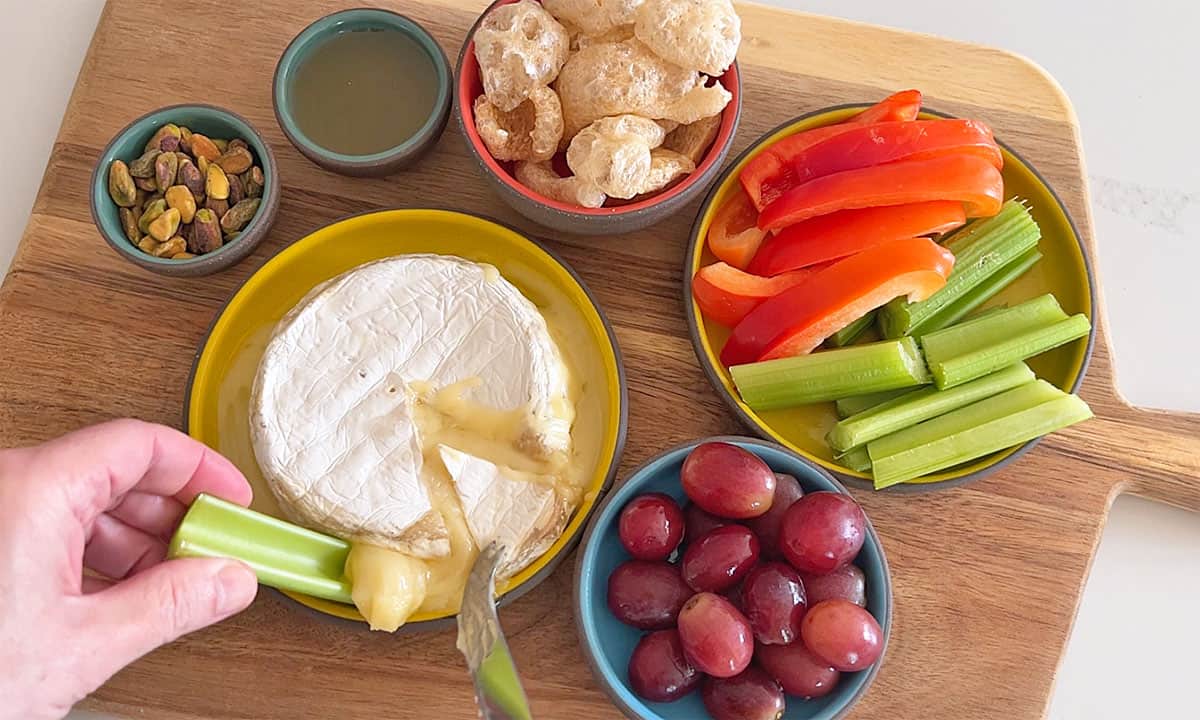 Scooping the cheese with a celery stick.