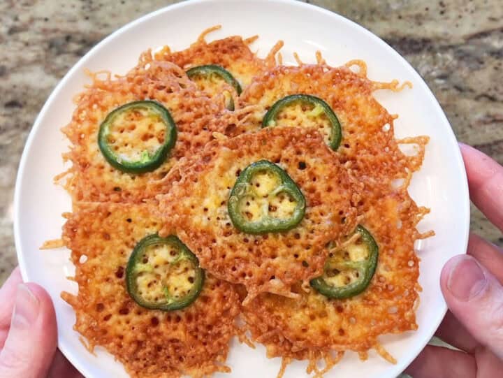 The cheese crisps are served on a plate.