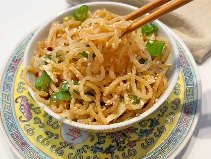 The noodles are served with chopsticks.