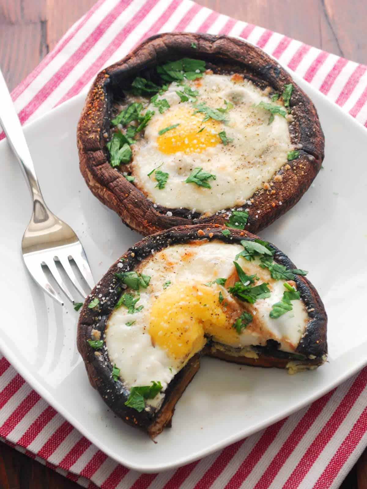 Breakfast mushrooms are served on a white plate.