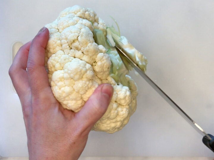 Trimming the cauliflower's stem.