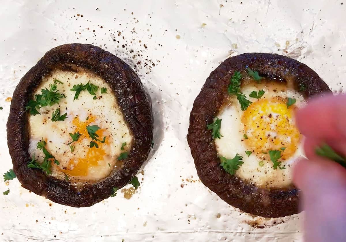 Garnishing the mushrooms with parsley.