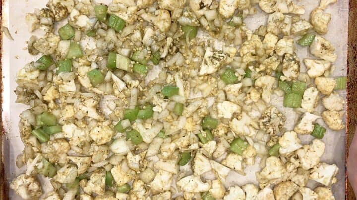 Spreading the veggies on the prepared pan.