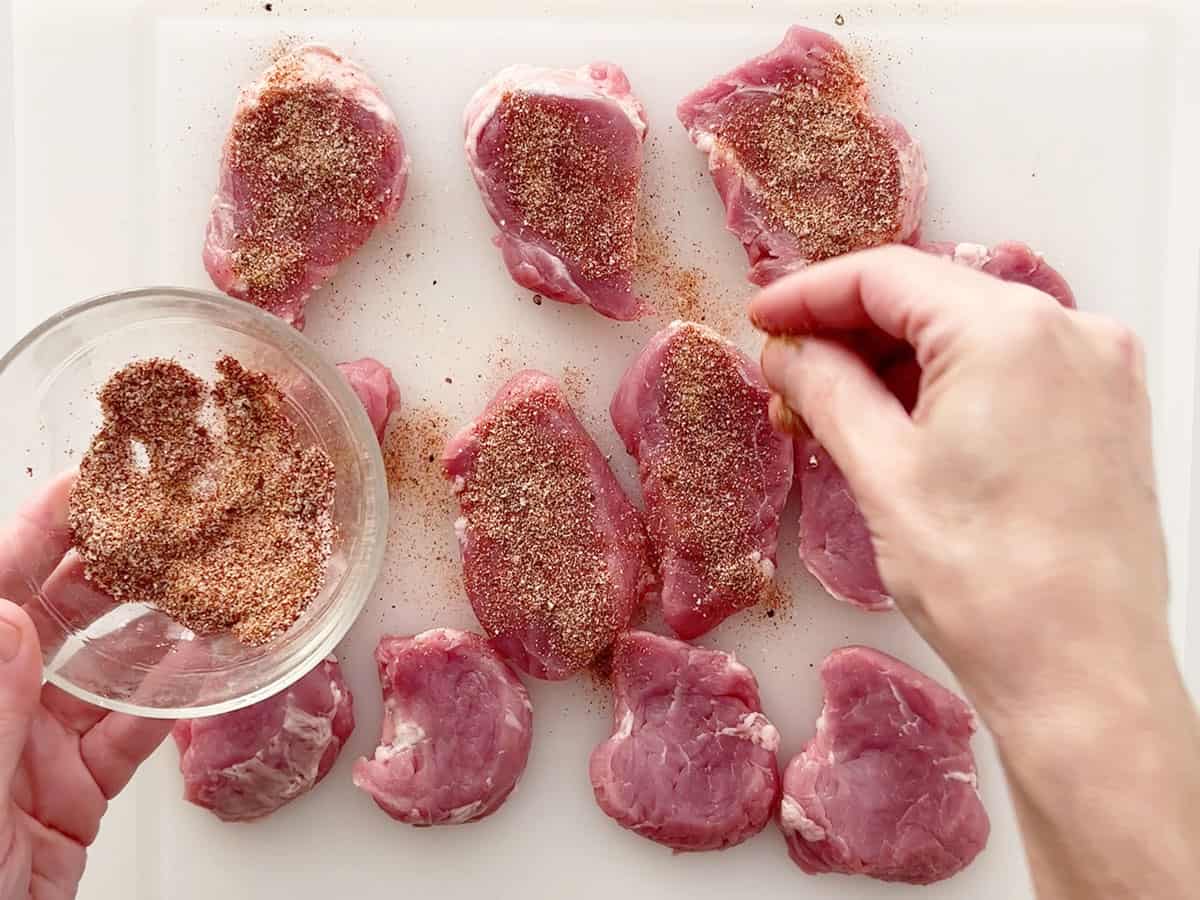 Seasoning the medallions.
