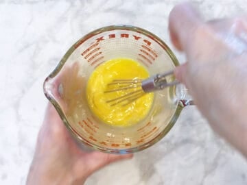 Whisking the eggs.