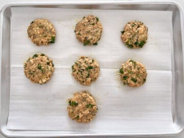 Mounds of salmon mixture on a baking sheet.