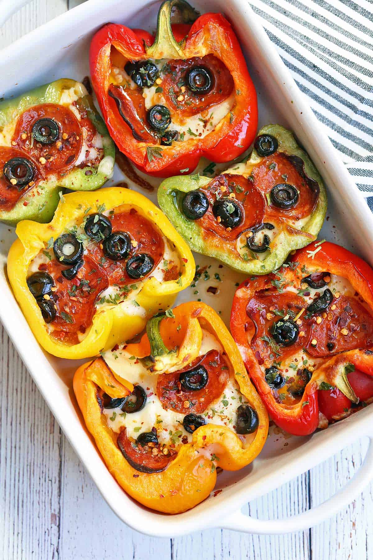 Pepper pizza is served in a white baking dish.