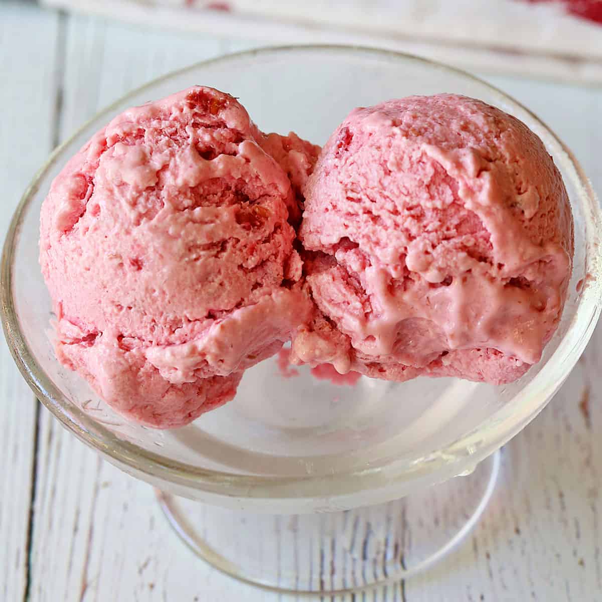 Raspberry frozen yogurt is served in a dessert bowl.