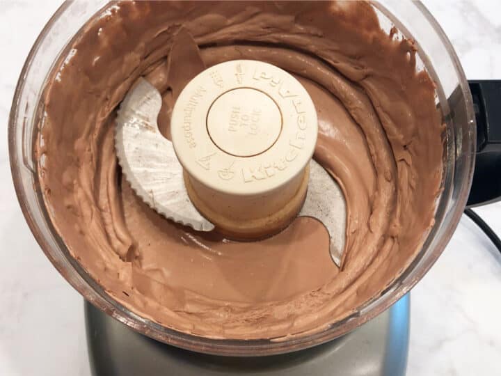 The whipped cream is ready in the food processor.