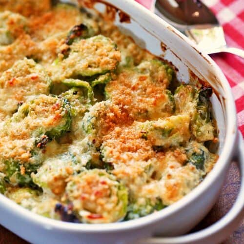 Brussels sprouts casserole is served in a white baking dish.