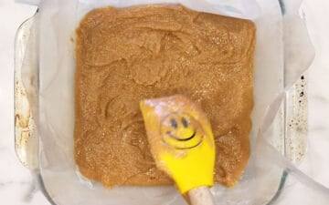 Spreading the bottom layer in the pan.