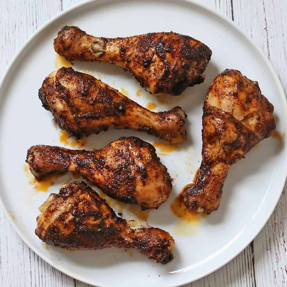 Chicken drumsticks seasoned with chili powder.