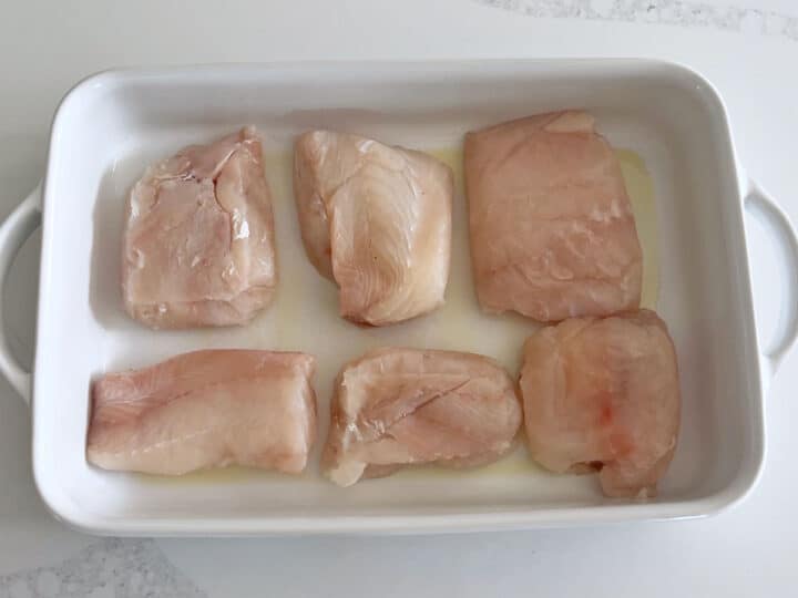 The fish fillets were arranged in the baking dish.