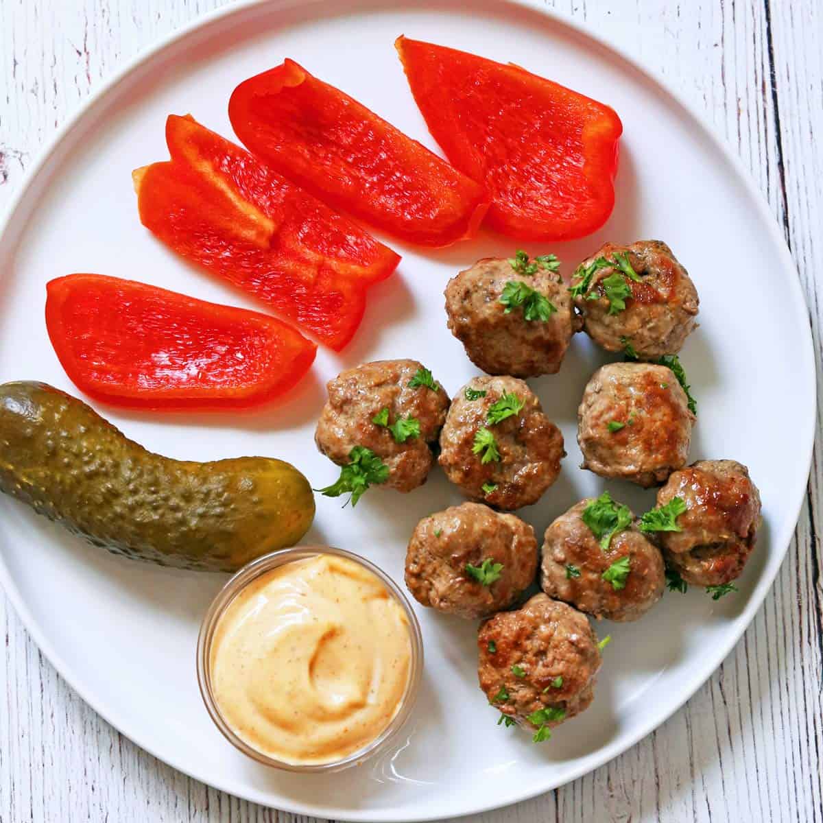 Leftover lamb meatballs are served with veggies, pickles, and sriracha mayo.
