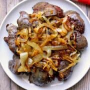 Chicken livers are topped with onions.
