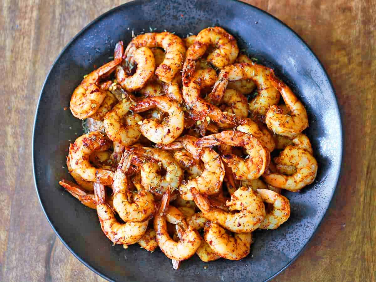 Tail-on shrimp on a plate.